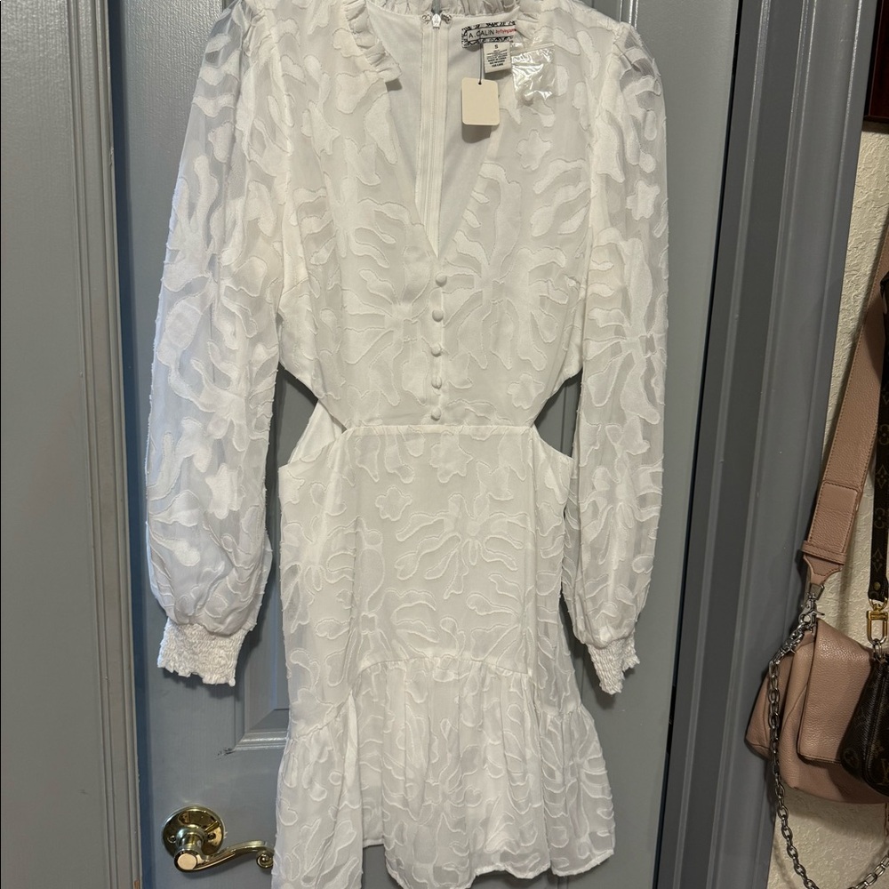 White, on white pattern cut out dress with mock buttons in the front. Never worn